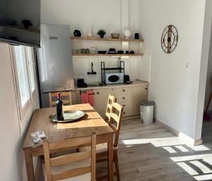 a kitchen with a table with a bottle of wine on it at Kastoria NYC in Kastoria