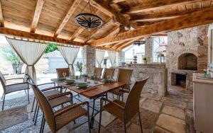 a dining room with a table and chairs at Rustic stone holiday house with pool in Marčana