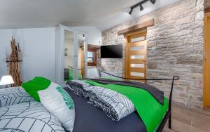 two beds in a bedroom with a stone wall at Rustic stone holiday house with pool in Marčana +51 photos