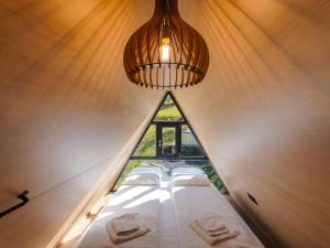 a room with four beds in a room with a window at Holiday Cabins in Hosasău