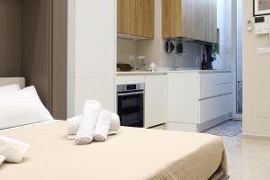 a bedroom with a bed with towels on it at Parva Domus Bari in Bari