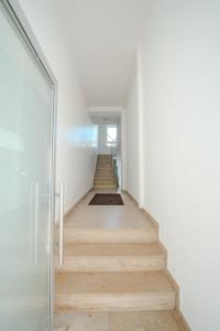 a hallway with a wooden floor and a stair case at Gästezimmer Kalb in Schweinfurt