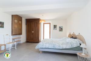a bedroom with a bed and a table and a window at Gîte des Mouliniers in Saint-Siméon-de-Bressieux +6 photos