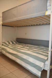 an empty bunk bed in a room at Maison douillette à 600m de la plage in Saint-Michel-Chef-Chef