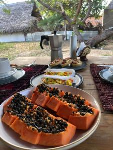 a table with a plate of food on it at Hausatins in Atins +71 photos