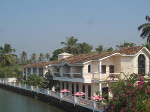 a view of the hotel from the river at Hotel Riverside in Baga