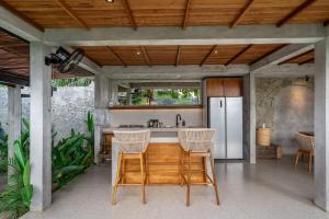 an outdoor kitchen with a counter and a refrigerator at Sola Villa Ubud in Ubud