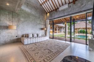 a living room with a couch and a table at Sola Villa Ubud in Ubud