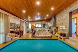 a home with a pool in the middle of a living room at Quinta de Santa Luzia in Santo Tirso