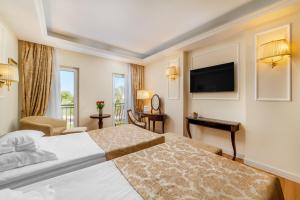 Postel nebo postele na pokoji v ubytování Hotel President Solin