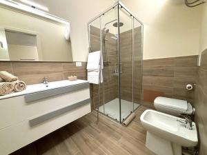 a bathroom with a shower and a sink and a toilet at A due passi da Piazza Cavalli in Piacenza