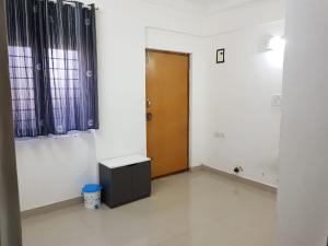 a room with a door and a table in it at C Suites - Cape Town in Bengaluru