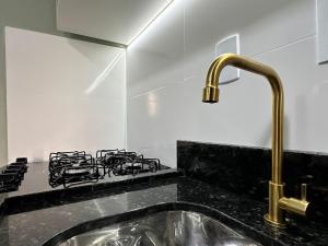 a kitchen with a sink and a stove at Residencial 305 - Localização privilegiada à 5min da praia in Bombinhas +55 photos