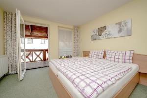 a bedroom with a large bed and a window at Landhaus Brodack in Alt Zauche