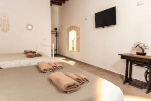 two beds with towels on them in a room at Il Girasole in Barletta