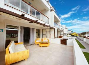 a patio with two couches and chairs on a house at Boutique Citadel in Eforie Nord