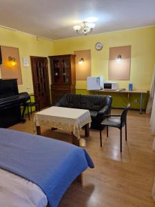 a living room with a couch and a piano at Apartament Erfolg 12 in Daugavpils +36 photos