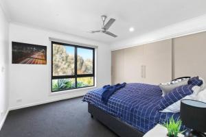 a bedroom with a bed and a window at Coastal Escape on Highlander in Torquay +3 photos