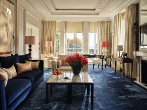 a living room with a couch and a table at Baur au Lac in Zurich