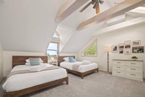 a bedroom with two beds and a ceiling at Farmhouse 1918 Grand Retreat for 12 people with Lake Views in Boyne City