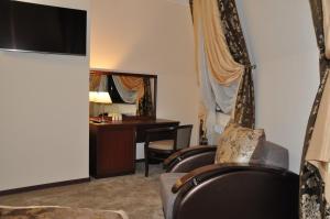 a living room filled with furniture and a tv at Bugar Hotel in Essentuki