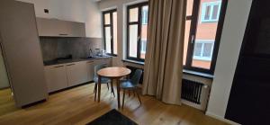 a kitchen with a table and chairs in a room at Room16-Ulm in Ulm