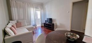 a living room with a couch and a table at Beautiful view close to Estádio da Luz in Lisbon