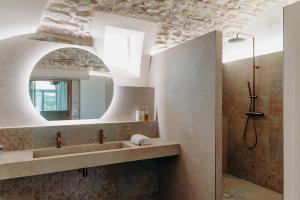a bathroom with a sink and a mirror at Hôtel Domaine de Biar in Montpellier