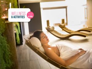 a woman laying in a hammock in a store at Hotel Excelsior - Liburnia in Lovran
