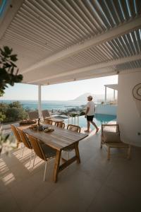 a person walking on a patio with a table and chairs at Villa Sávra in Plakias