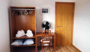 a room with a closet with a desk and a door at The Music House, Ilha Terceira, Açores in Praia da Vitória