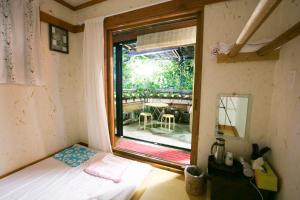 a small room with a bed and a window at Bukchonmaru Hanok Guesthouse in Seoul