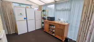 a kitchen with two refrigerators and a wooden table at Kirk Lea in Halifax