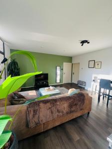 a living room with a large couch in the middle at Canal apartment at historic CityCenter Amersfoort in Amersfoort