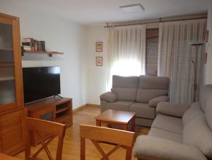 a living room with a couch and a flat screen tv at R2R - Apto espacioso en Cabrales - 24B03 in Arenas de Cabrales