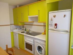 a kitchen with green cabinets and a white refrigerator at R2R - Apto espacioso en Cabrales - 24B03 in Arenas de Cabrales