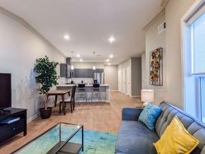 a living room with a blue couch and a kitchen at 313 brand new 3 bedroom 2 bath in Dunellen