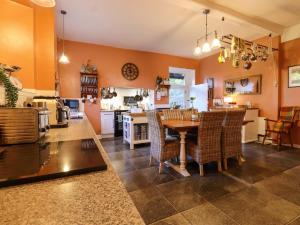 a kitchen and dining room with a table and chairs at Goss Hall in Canterbury