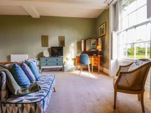 a living room with a couch and a window at Goss Hall in Canterbury