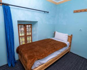 Uma cama ou camas num quarto em Gite Tamounte