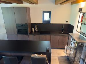 a kitchen with wooden cabinets and a black counter top at KVillas in Severin na Kupi +17 photos