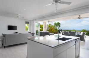 a kitchen and living room with a view of the ocean at Westmoreland Modern sea View Villa with pool in Saint James