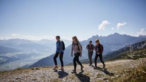 a group of people walking on top of a mountain at Der Brandstetterhof - Adults only in Stans