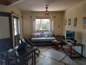 a living room with a couch and a table at Casa na linda praia de Jericoacoara in Jericoacoara