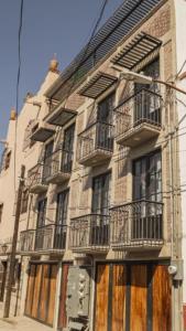 a building with balconies on the side of it at Romance en San Miguel in San Miguel de Allende