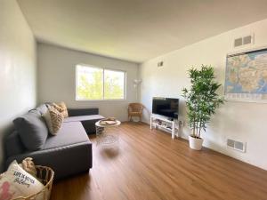 a living room with a couch and a tv at Private BR,BA,KIT, LR 9 Mins to Beach in Edgemere