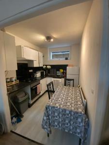 a kitchen with a table and chairs in it at Homewood - entire property for 6 people - 4 adults maximum - in village 10 min from Disneyland Paris & TGV RER A in Montry