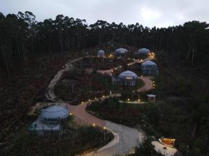 an aerial view of a house with lights on a hill at GLAMPING DO MAR in Baiona