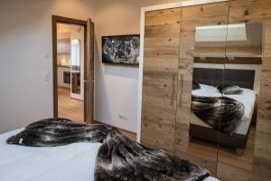 a bedroom with a bed with a glass wall at Panorama Ski Lodge in Zermatt