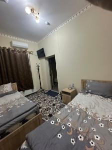 Ένα ή περισσότερα κρεβάτια σε δωμάτιο στο Hostel Boburshokh +3 φωτογραφίες